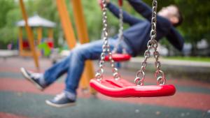 Un niño juega en un columpio