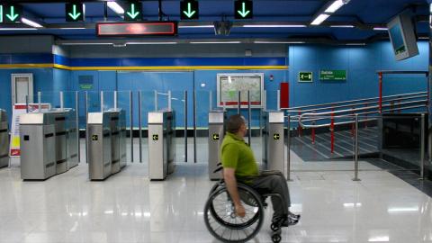 Persona en silla de ruedas en un vestíbulo de Metro
