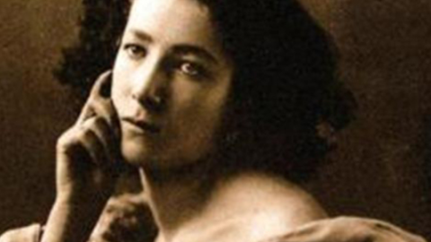 Retrato antiguo de mujer morena sobre tejidos rojos