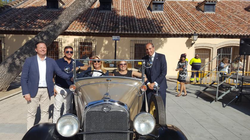 La DG de Comercio y Consumo, María José Pérez-Cejuela, junto a todos asistentes posa junto a un coche de época durante la presentación de la quinta e