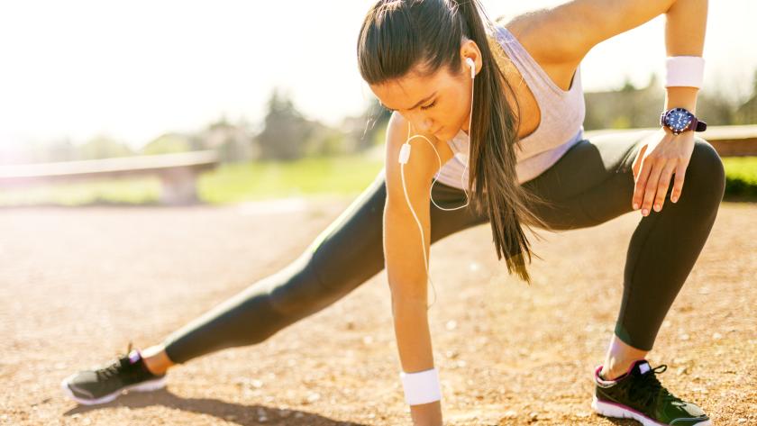 Una joven estirando antes de hacer deporte