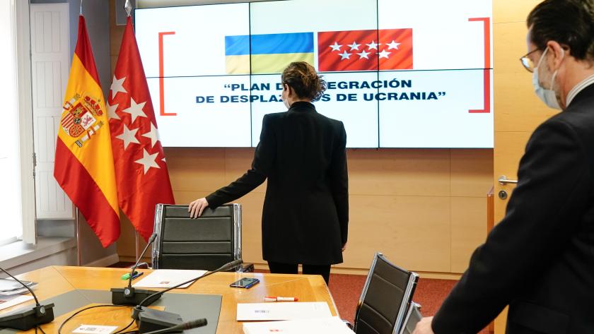 La presidenta Isabel Díaz Ayuso preside la primera reunión del Comité de Crisis de Ucrania La presidenta de pie y de espaldas, apoyada en la silla del comité