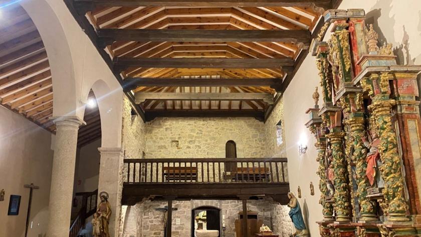 nave rectangular de iglesia con artesonado de madera coro y bancos de madera, pila bautismal de piedra y retablo polimocromado en un lateral