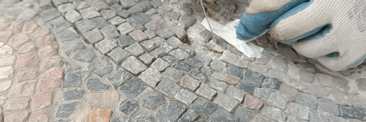 unas manos restaurando un mosaico