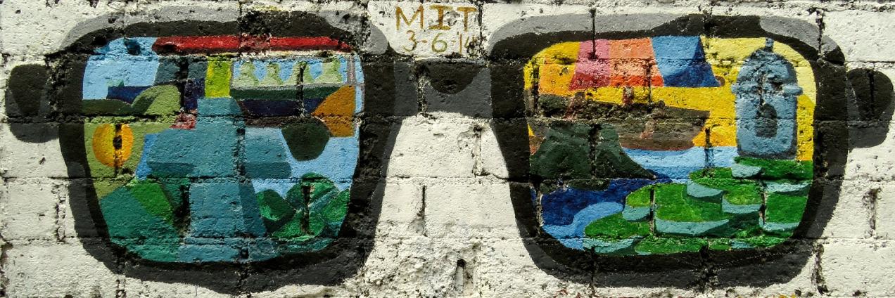 Imagen de una pared con un graffiti de unas gafas