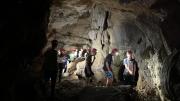 Jóvenes dentro de una cueva con cascos rojos
