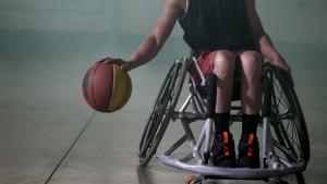 Deportista con discapacidad Un atleta discapacitado en silla de ruedas jugando al baloncesto