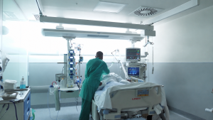 Médico al lado de una cama de hospital