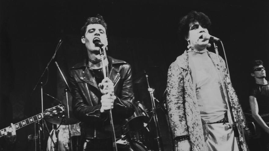 Two men sing on a stage