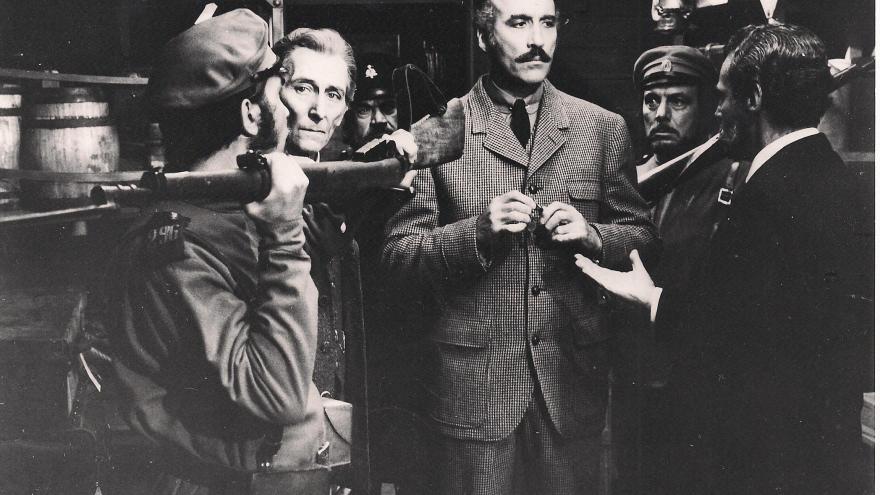 Several men and soldiers inside a train car