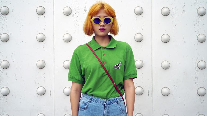 Young boy/girl dressed fashionably and posing in front of the camera