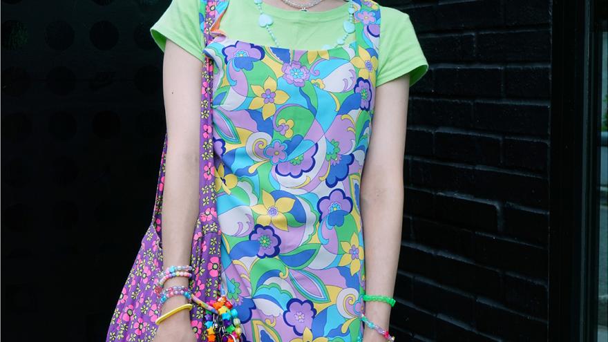 Young boy/girl dressed fashionably and posing in front of the camera