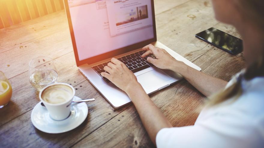 Woman writing on a laptop