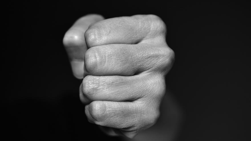 hand fist coming out of the dark