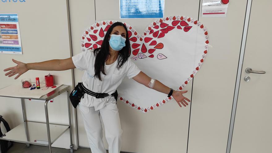 Nurse in front of blood donation mural