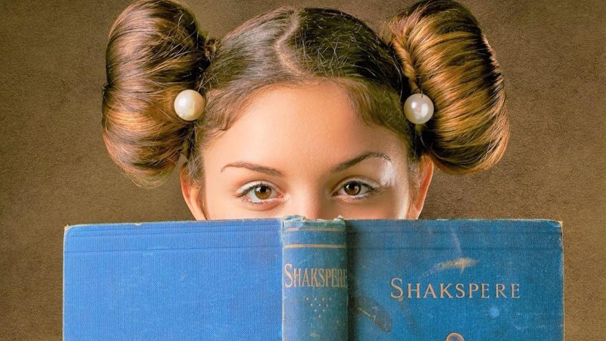 Girl with a book in front of her face