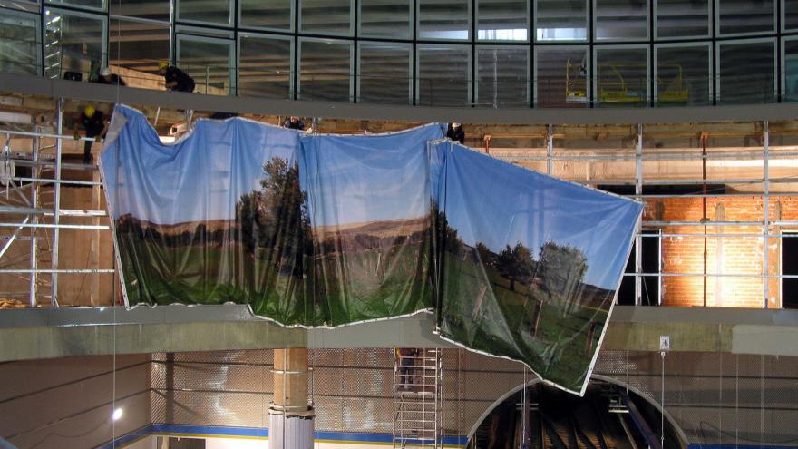 Hoisting process of the mural with pulleys