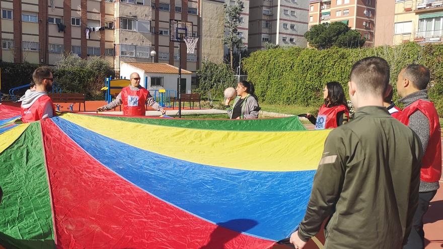 Young people holding a colored parachute