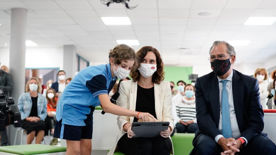 La presidenta mirando en una tablet donde una niña le señala algo