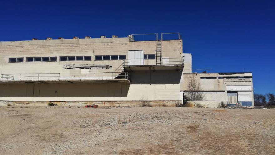 Image of concrete building with glass windows and external stairs