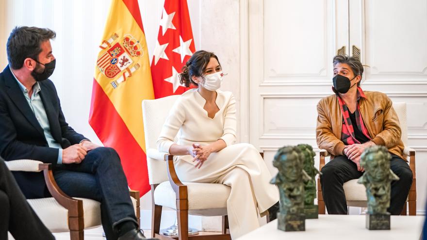 La presidenta sentada conversa con los galardonados