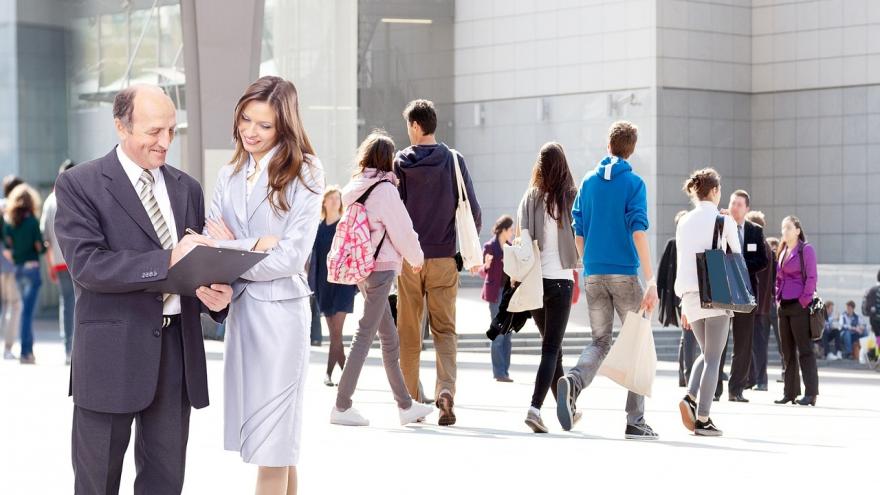 Scene of people on the street with a close-up of two of them reaching an agreement