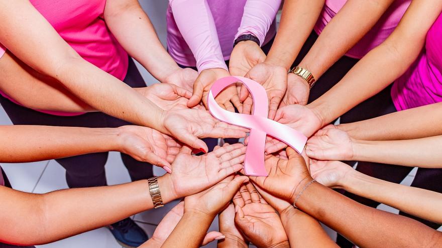 Manos mujeres unidas símbolo cáncer de mama