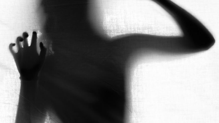 fotografía de una mujer tras un cristal traslucido , golpeando el cristal 