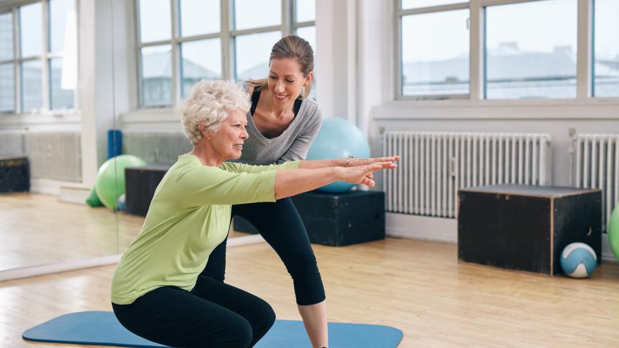 Monitor de actividad física ayudando a una persona mayor