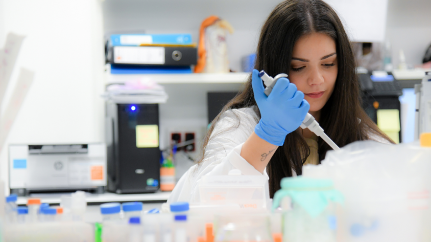 mujer con pipeta en laboratorio