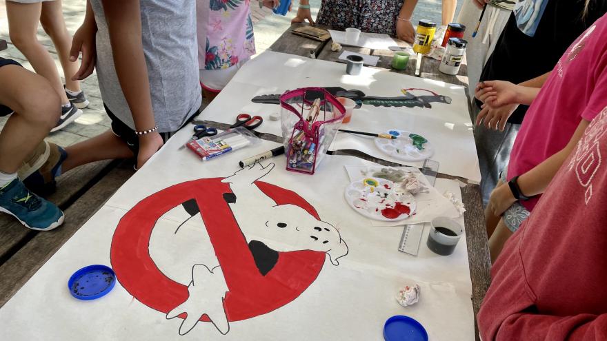 Table with crafts and children around