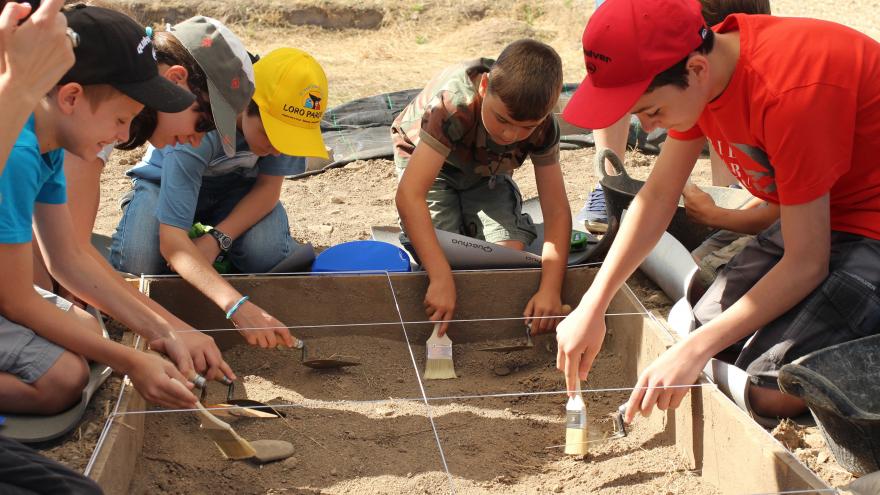 A group of children carry out archeology work