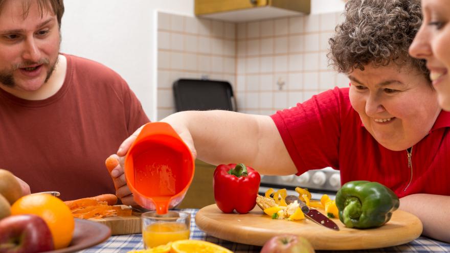 Persona con discapacidad preparando un zumo en un hogar residencial