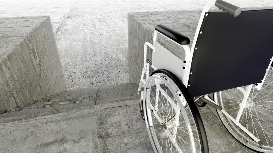 Una silla de ruedas frente a una escalera
