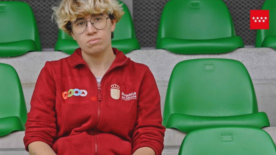 Woman sitting on a seat in a football stadium