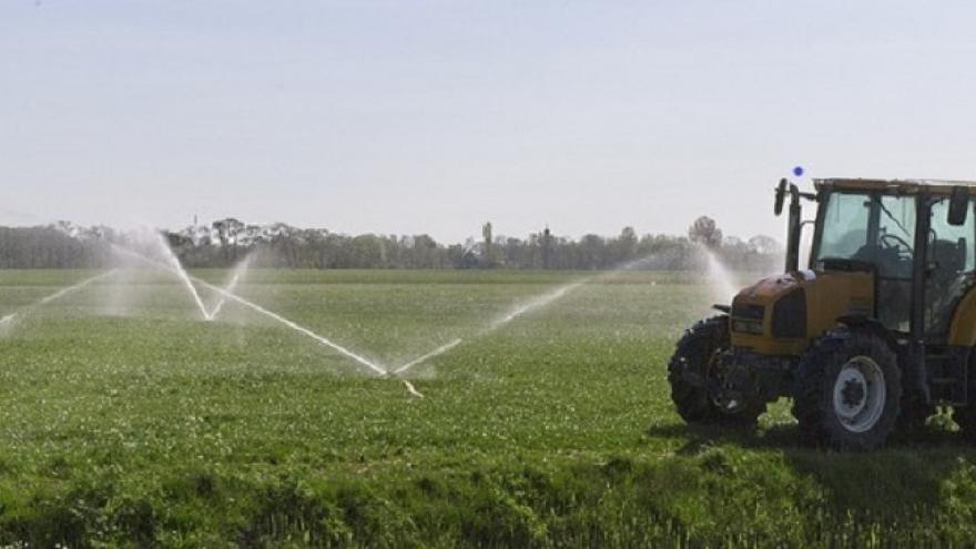 Photo of tractor in a field irrigating