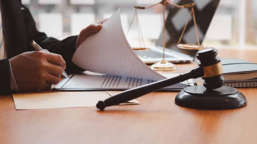 A judge signing a document