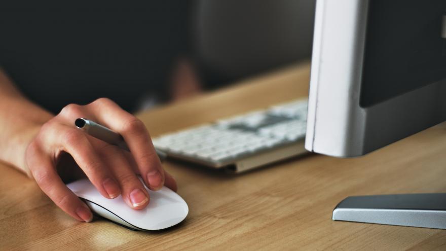 A person doing tasks with a laptop