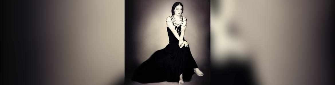 Seated woman in a black dress