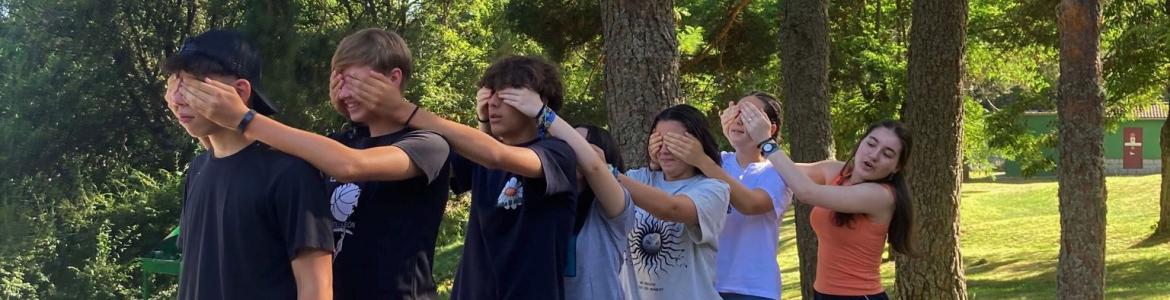 young people in a row covering their eyes