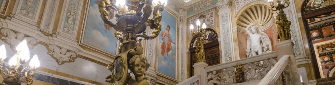 interior staircase of palace with lamp in foreground