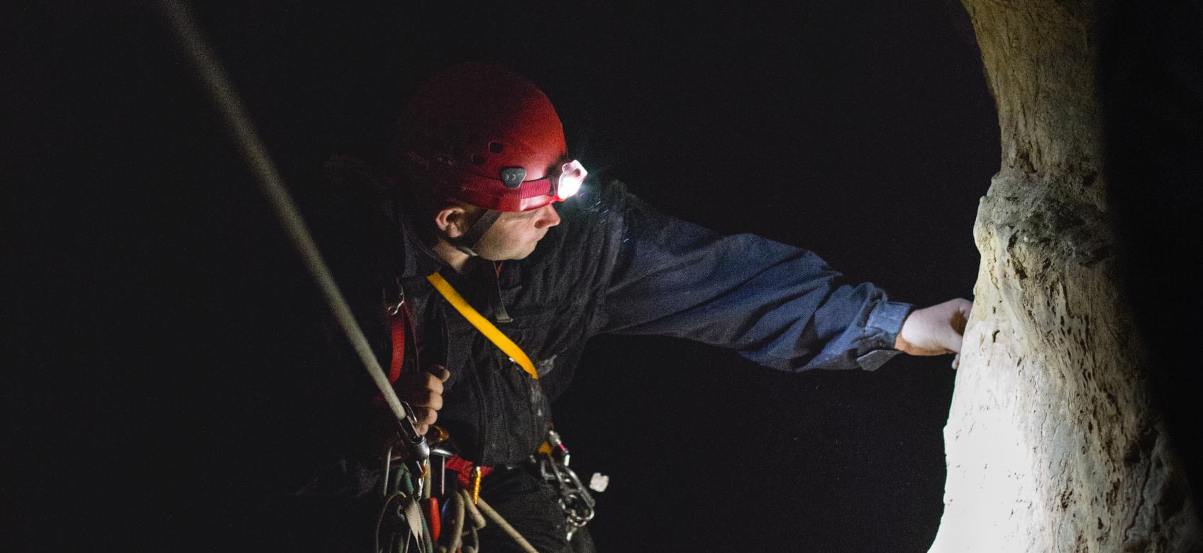 man practicing caving