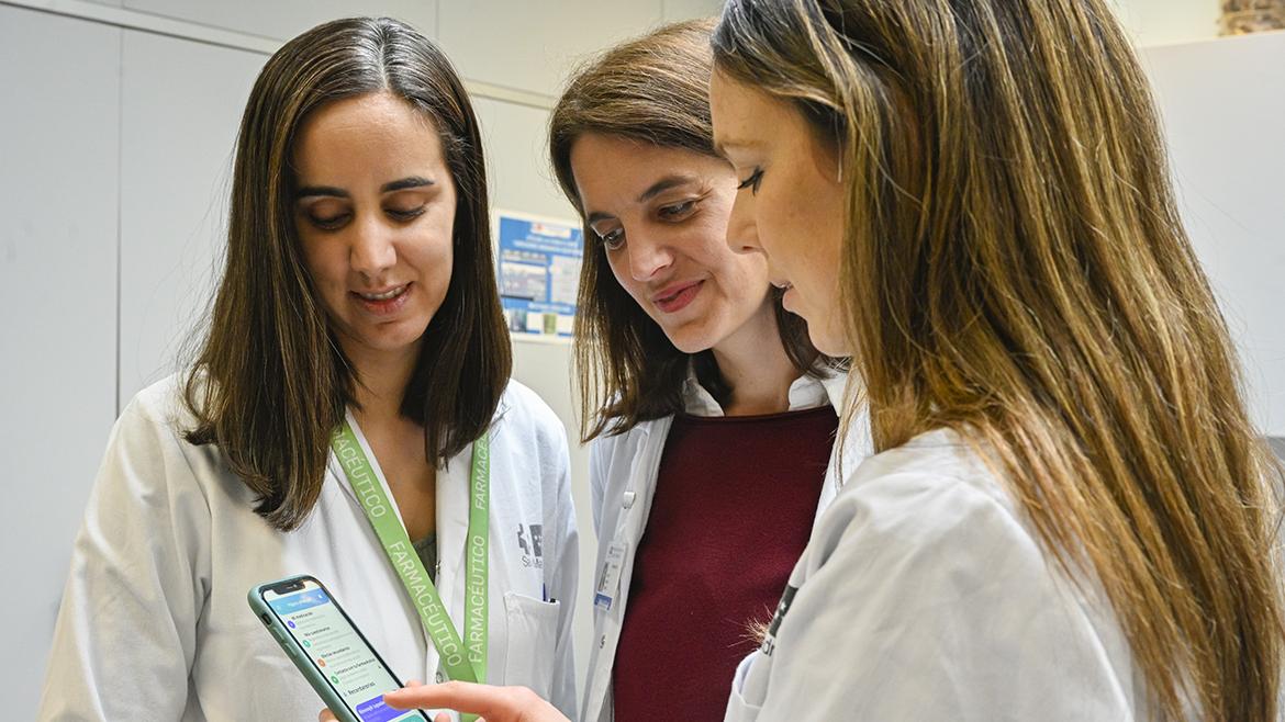 Farmacéuticas del hospital consultan una aplicación móvil