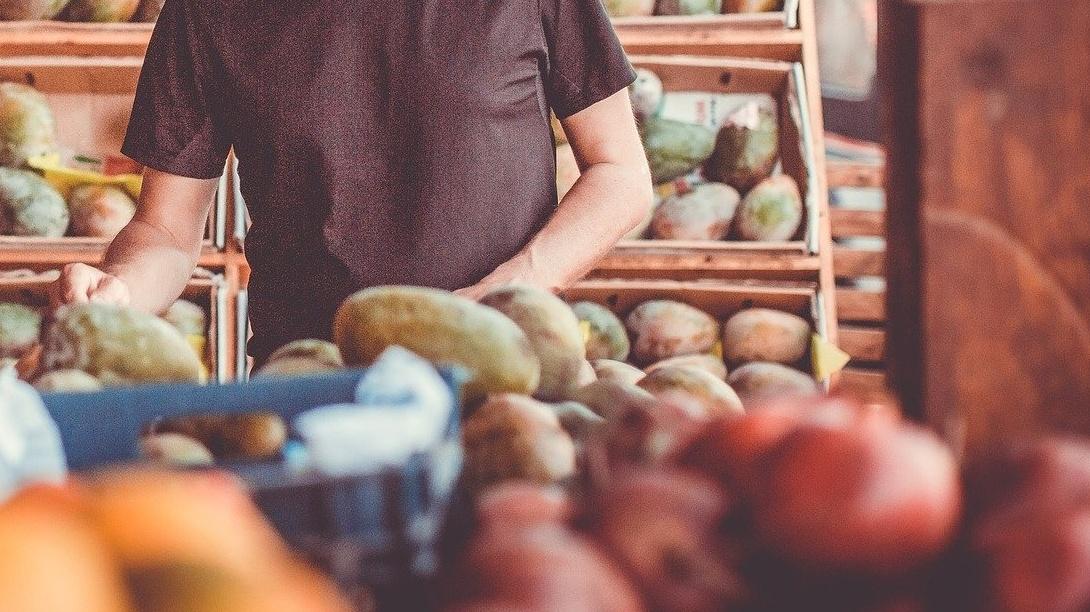 Un hombre coge frutas en una tienda