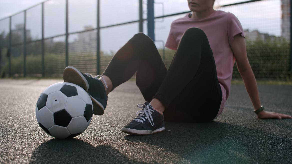 Woman with ball at her feet