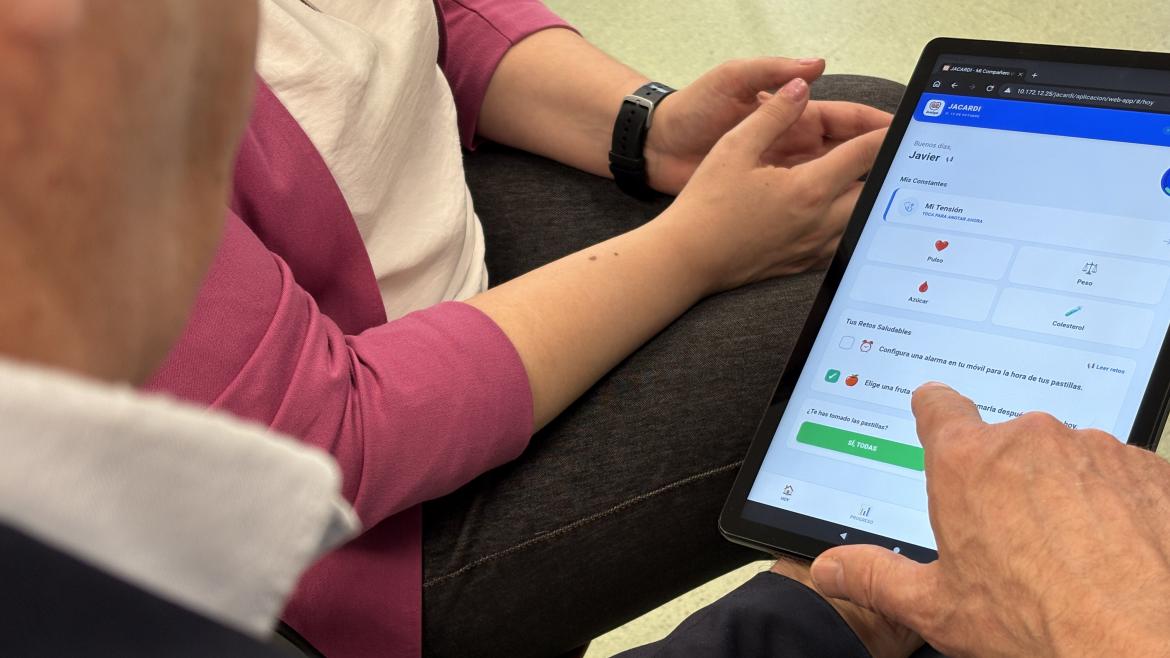Mano de persona mayor que señala un contenido en una tablet