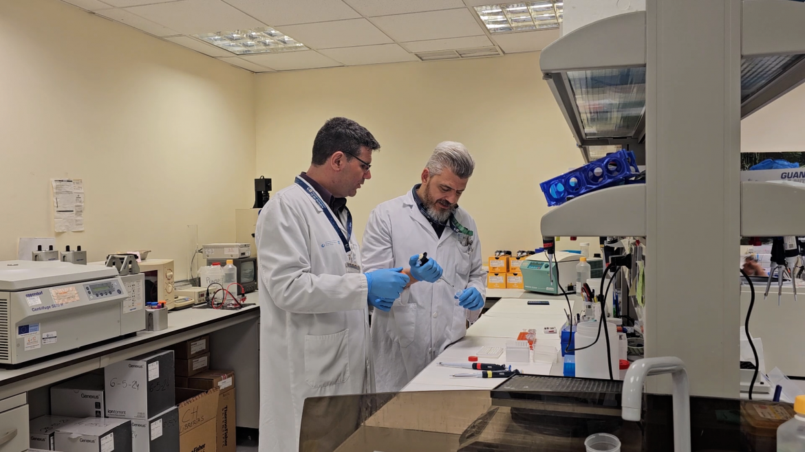 dos profesionales con bata blanca en laboratorio pipeteando