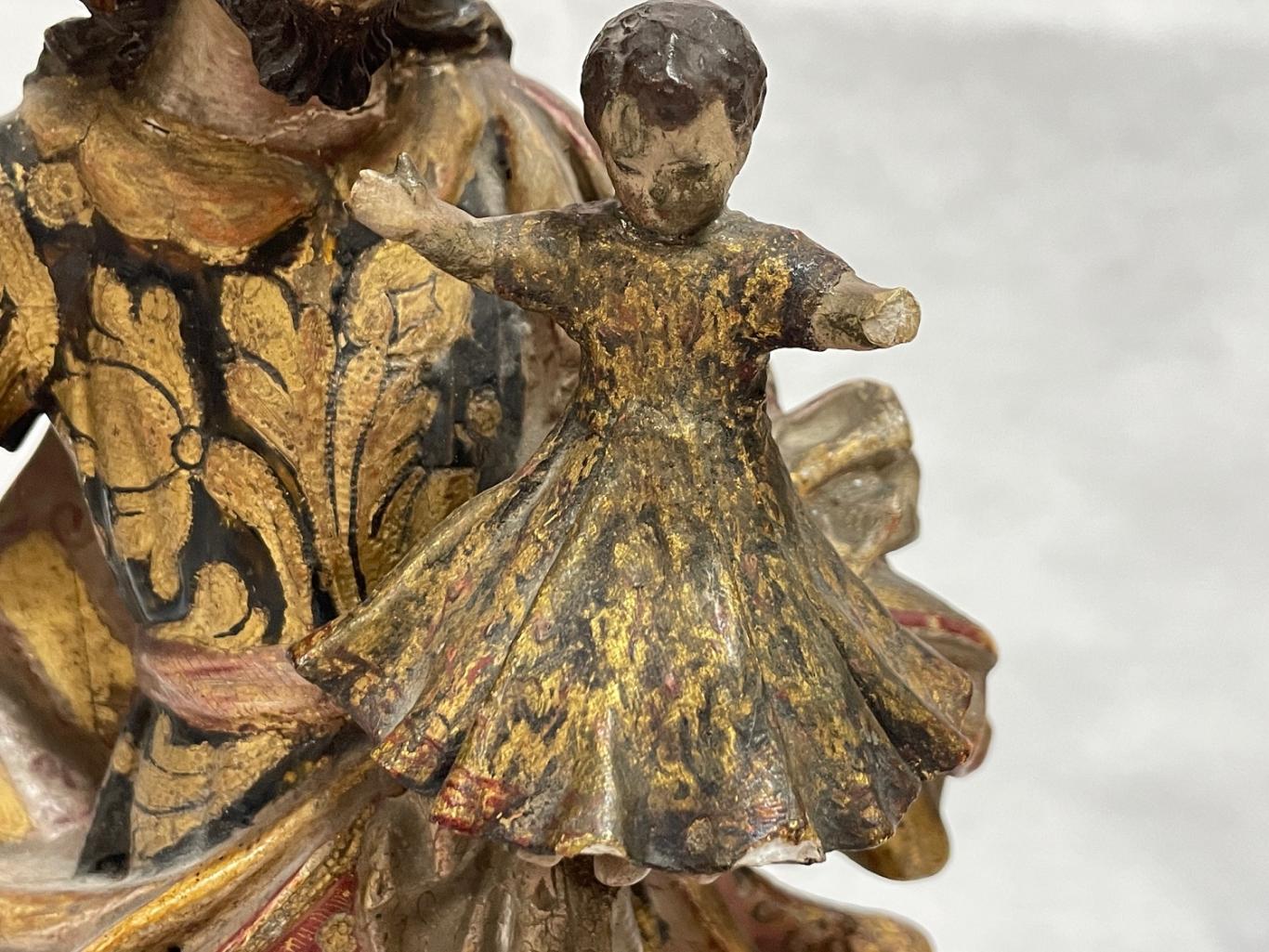 Detalle del Niño Jesús sostenido por San José antes de la restauración