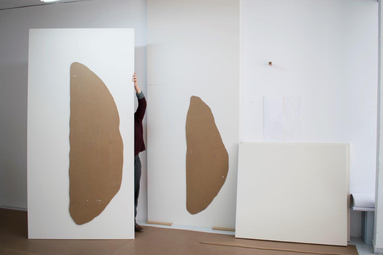 Three white panels with brown patterns in the center