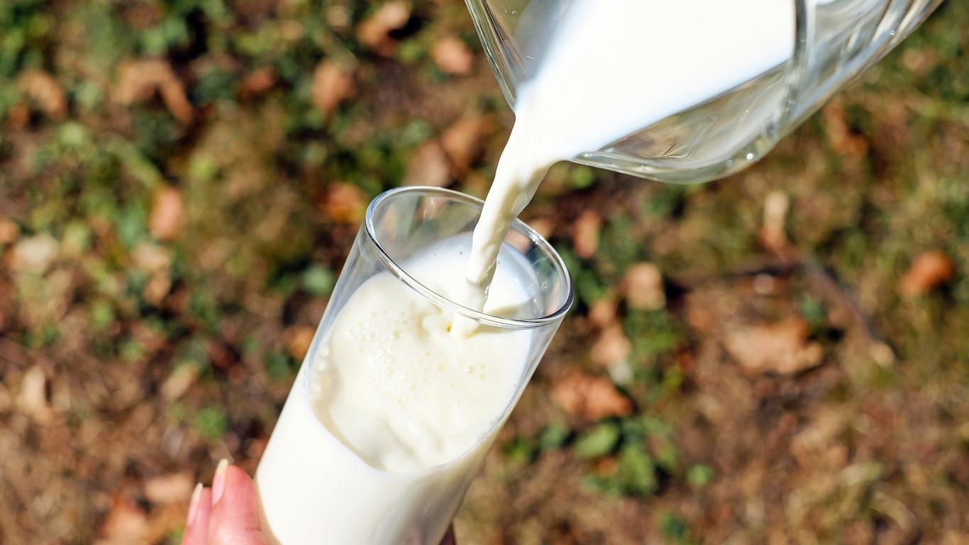 Jarra de leche sirviendose en un vaso